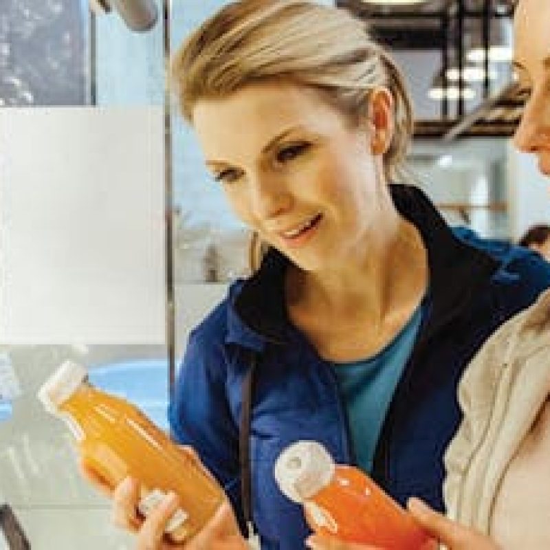 Women comparing antioxidant bevarages in a health cafe after working out.